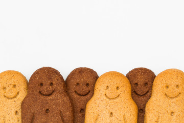 Rows of black and white, happy and smiling gingerbread men on a white background representing racial diversity and equality.