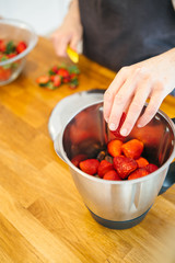 Hands peeling fresh strawberry