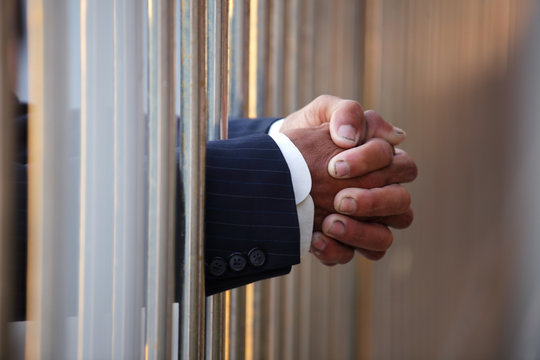 hand of businessman in jail as background.