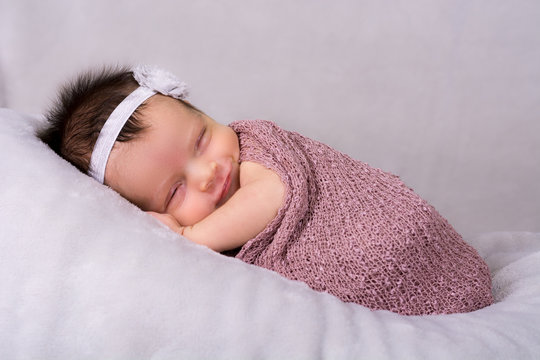 Beautiful newborn baby girl wearing a smile