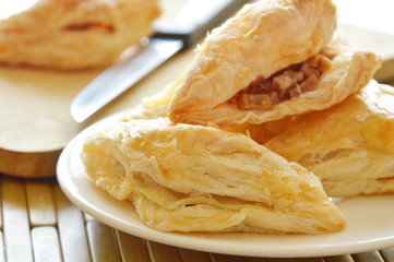 crispy pie filled pork sausage and crushed bean with wooden chop block