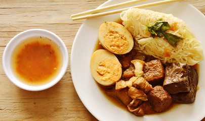 thin rice noodle with pork entrails and tofu topping egg on dish