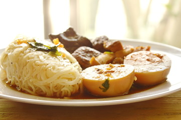 thin rice noodle with pork entrails and tofu topping egg on plate