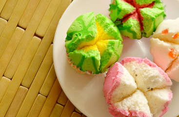 assorted colorful cotton cupcake in paper on dish