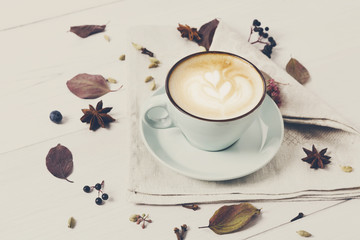 Spicy cappuccino coffee cup on white wood background