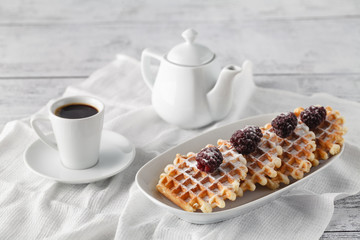 Few wafers on table with berries and coffee