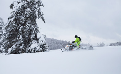 Winter Finnish snowy lanscape with road and snowmobile