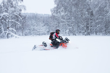 Fototapeta na wymiar Winter Finnish snowy lanscape with road and snowmobile