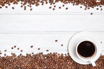 Coffee mug and coffee beans on the table. Copyspace for text.