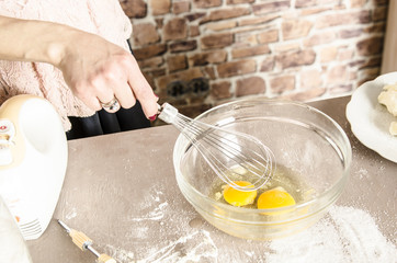 Beautiful picture of eggs in a white bowl with beaters near yolk