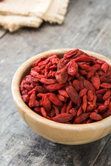 Wolfberries or Goji berries in bowl on wooden table
