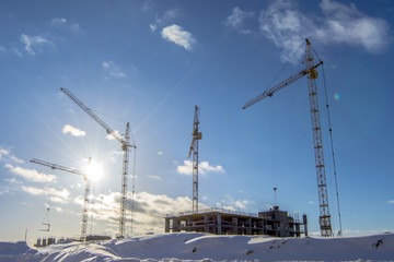The construction of new houses on a background sky