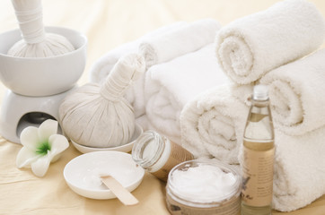 Obraz na płótnie Canvas Spa treatment with towels and herbal creams and scrubs on beautiful soft background