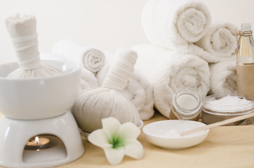 Spa treatment with towels and herbal creams and scrubs on beautiful soft background