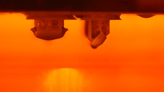 DPL 3d printer create small detail and liquid drips, platform slowly move from vat with liquid close-up. Progressive modern additive technology 3D printing, create scaled model by UV polymerization