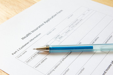 Blank health insurance application form with pen wait for fill d