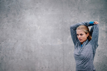 Female runner stretching arms after a running session