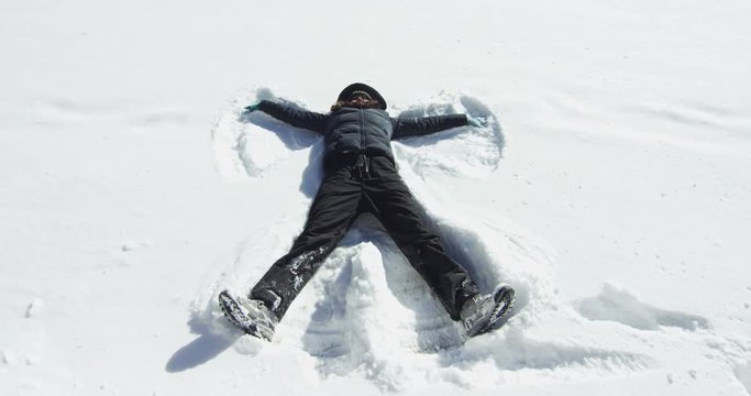 Girl making snow angel