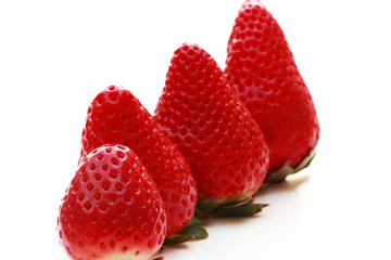 Tasty strawberries of different sizes isolated on white background