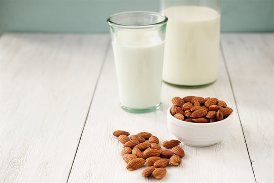 Almonds and almond milk in the background 
