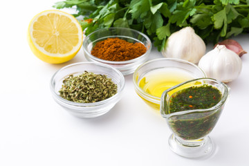 Green Chimichurri Sauce and ingredients isolated on white background
