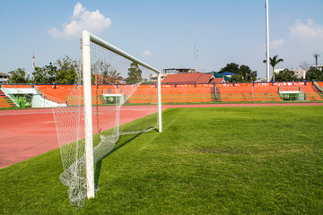 Obraz premium A stadium is a place for outdoor sports consists of a field or stage either partly or completely surrounded by a tiered structure designed to allow spectators to stand or sit and view the event.