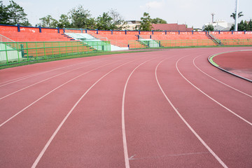 Obraz premium A stadium is a place for outdoor sports consists of a field or stage either partly or completely surrounded by a tiered structure designed to allow spectators to stand or sit and view the event.