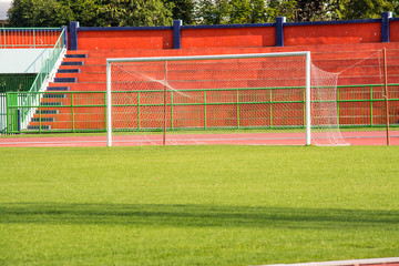 Fototapeta premium A stadium is a place for outdoor sports consists of a field or stage either partly or completely surrounded by a tiered structure designed to allow spectators to stand or sit and view the event.