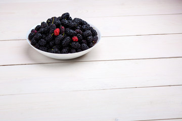 Fototapeta na wymiar mulberry in white plate, top view