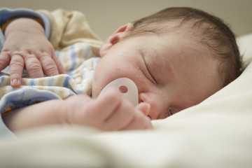 baby sleeping with a pacifier