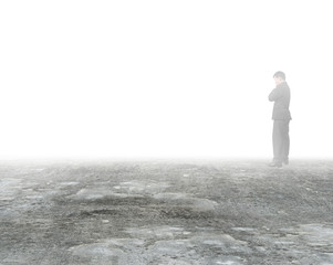 Man thinking and standing in mist on dirty concrete floor - Powered by Adobe
