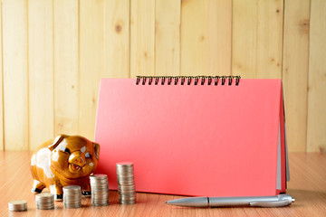 finance stack coins, calculator and piggy bank on wood table and copy space mock up 