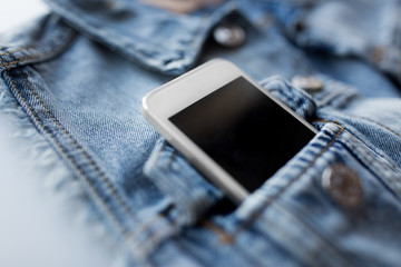 smartphone in pocket of denim jacket or waistcoat