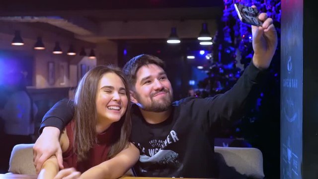 Young Happy Smiling Couple doing Selfie with Mobile Phone. HD.