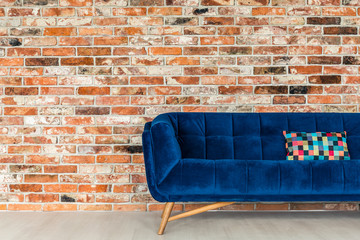 Blue sofa with patchwork pillow