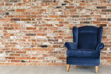 Industrial brick wall and armchair - obrazy, fototapety, plakaty