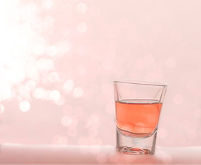 singgle glass shot with pink bokeh background