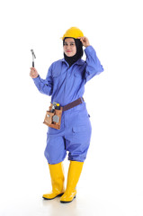 Construction worker wear yellow safety helmet in action while holding a hammer