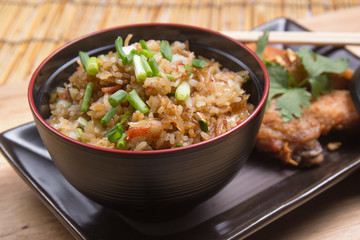 Fried chicken wings served with fry rice