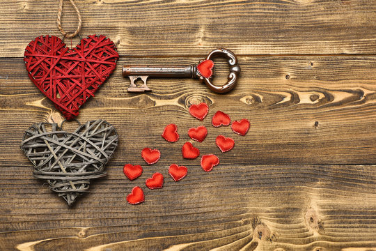 straw heart and metallic key on wood as valentines decoration