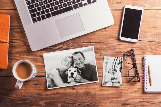 Office desk. Objects and black-and-white photos of senior couple