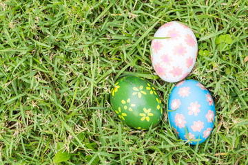 Top view of easter eggs on green grass background
