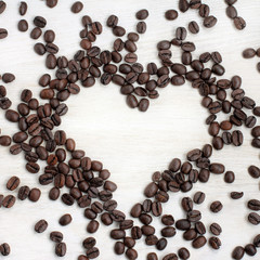 aromatic signs of love/ lay flat on a table of scattered coffee beans in the shape of a heart 