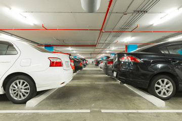 Parking garage interior with cars in industrial building, modern