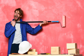 shouting man holding paint roller