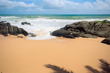 Fototapeta na wymiar Tropical beach with stones in Sri Lanka, Ambalangoda