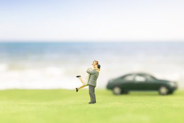 Miniature couple on the beach background