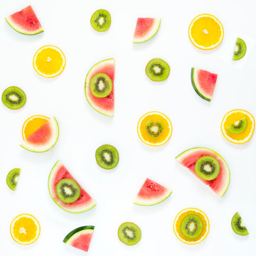 Colorful pattern of kiwi, oranges, watermelon. Top view of sliced fruit. Ingredients for a summer cocktail.