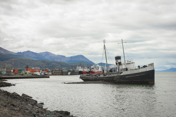 Ushuaia, Argentina; shipwreck of Saint Christopher stranded in the port of Ushuaia. The Saint Christopher was an America-built rescue tugboat that served in the British Royal Navy