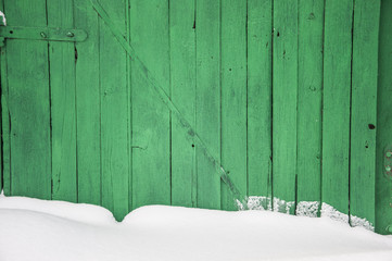 Old wooden fence, covered with snow